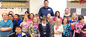 RSU student posing with elementary school students.