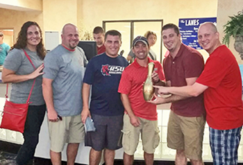 Group of people with trophy.