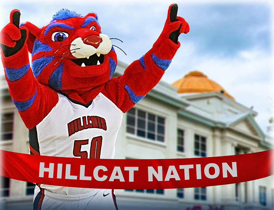 Hunter the Hillcat running with #1 fingers up in the air.