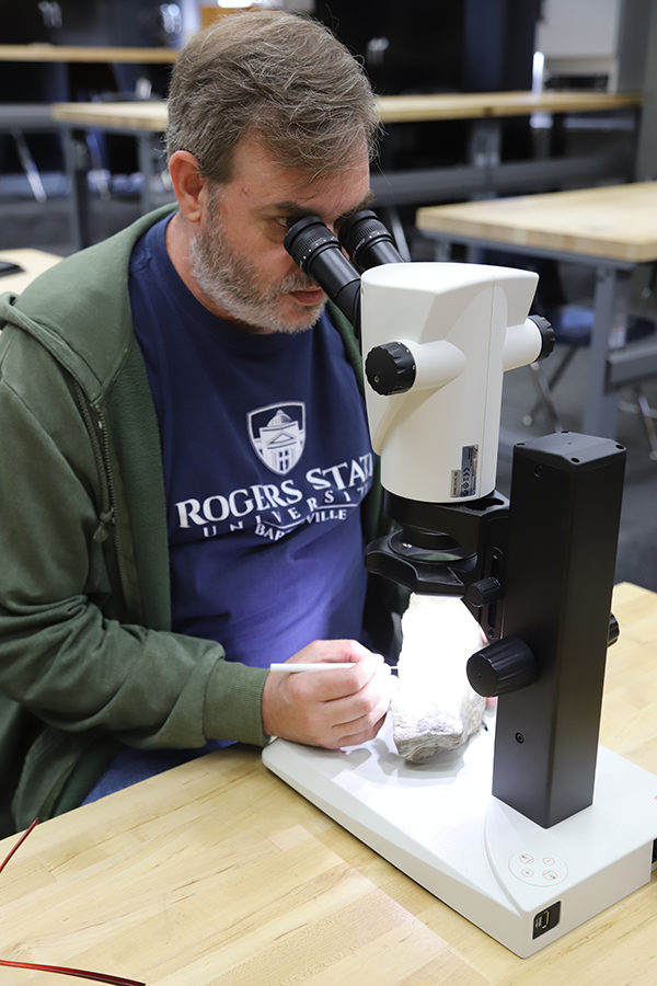 Dr. Chris Shelton looking into a microscope