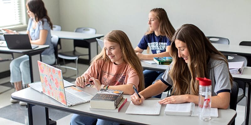 Girl on a laptop in a classroom
