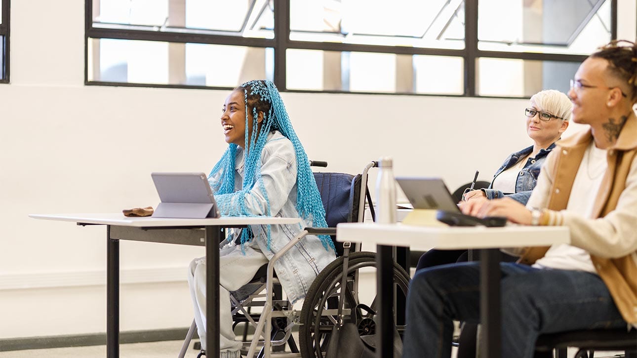 Student in a wheelchair enjoying learning in class