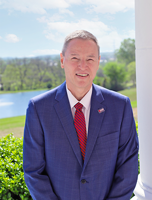 President Don Raleigh standing outside