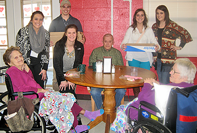 Students delivering cookies to nursing home.