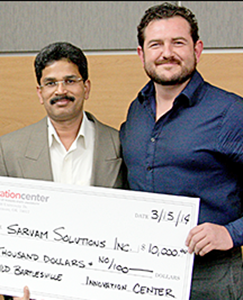 Two men holding a large check.