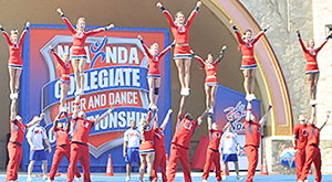 Cheerleaders doing a stunt in their routine.