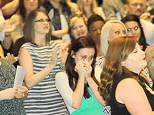 RSU Nursing Graduate Lauren Chapman reacts to a video of her husband, U.S. Army Spc. Dax Chapman, congratulating her on her graduation from RSU's nursing program.