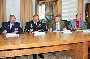 (from left) NMMI Academic Dean Brigadier General Douglas Murray, NMMI Superintendent Major General Jerry Grizzle, RSU President Dr. Larry Rice and RSU Vice President for Academic Affairs Dr. Richard Beck sign an articulation agreement between the two schools.