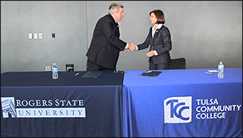 RSU President Larry Rice shakes hands with TCC President Leigh Goodson