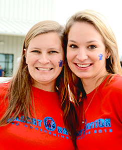 Two girls with paws painted on cheeks.