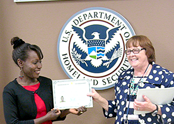 Dr. Juliet Evusa receives her citizenship certificate.
