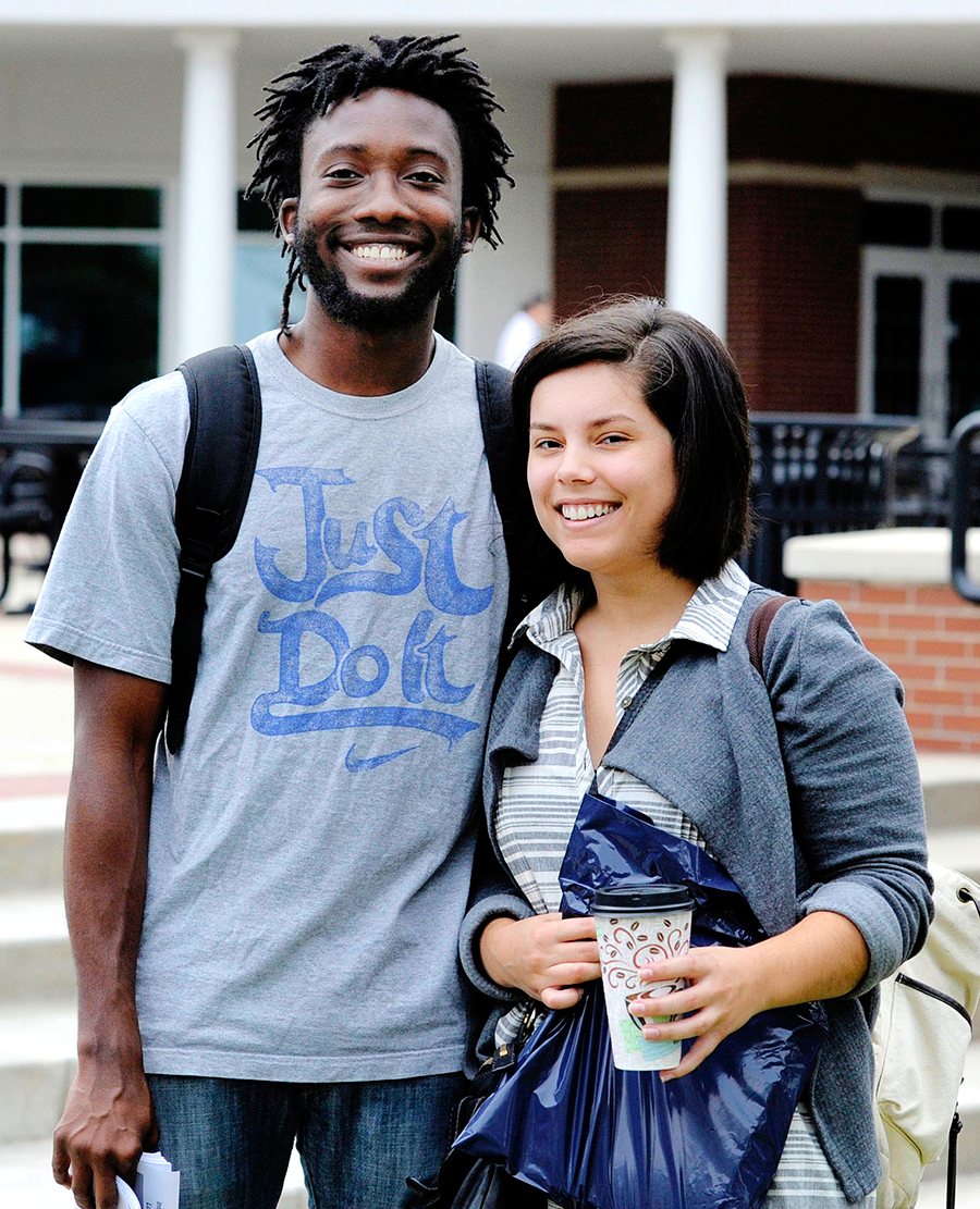 Boy and Girl standing next to each other on the patio of the Centennial Center.