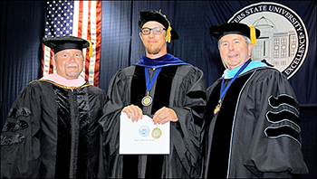 Dr. Beck, Dr. Andrews (holding award) and Dr. Rice