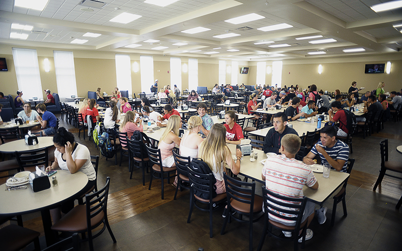 students eating in the dining room at college