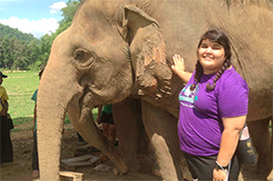 Layna petting an elephant.