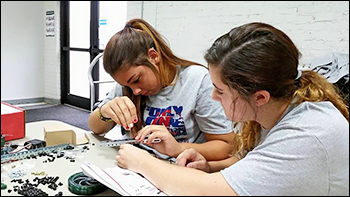 Skiatook High School students Sierra Shannon and Jaci Mashburn build a robot during a Talent Search camp at Rogers State University. 