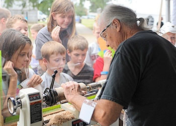 Artist Jerry Emanuel demonstrates woodturning for Art on the Hill festival-goers. 