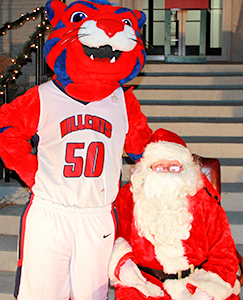 Hunter staning next to Santa Clause.