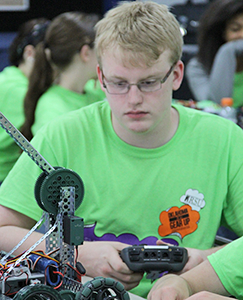 Boy working on robot during the A.R.T. Academy