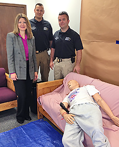 Instructor Holly Cinocca and RCSO officers pose next to mannequin used to represent the deceased.