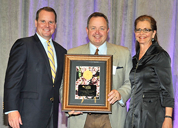 RSU TV General Manager Royal Aills, center, holding the award.