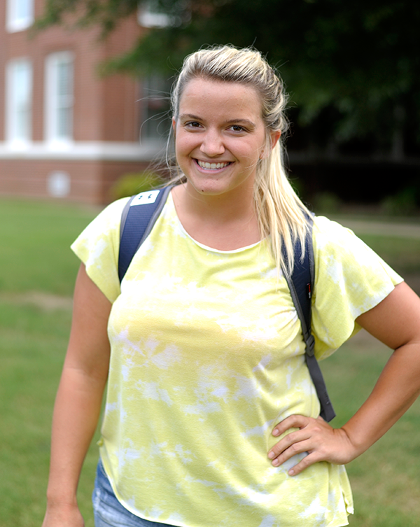 Girl in ponytail with backpack.