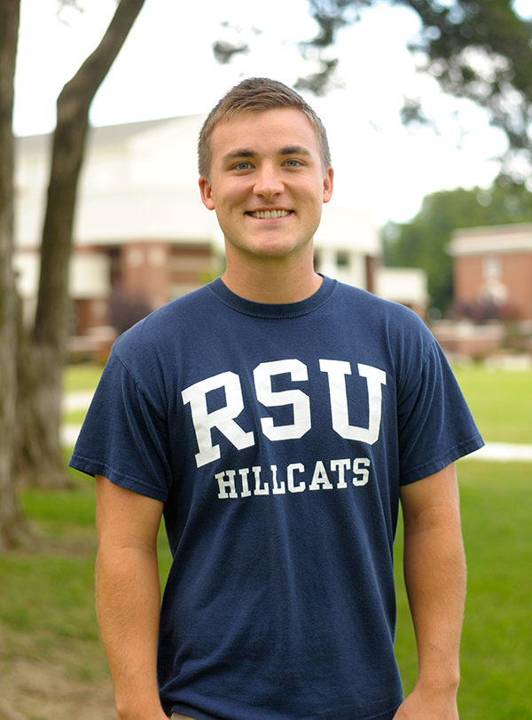 Boy wearing blue RSU Hillcats shirt.