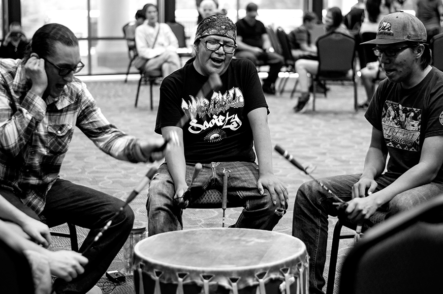 Black and white photo of men playing drums at Native American Festival