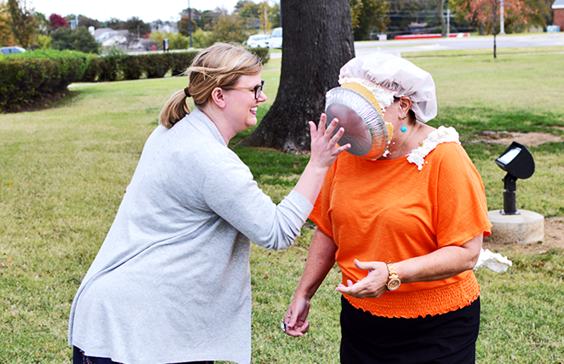 Professor Mackey throwing a pie in Dr. O'Malley's face.