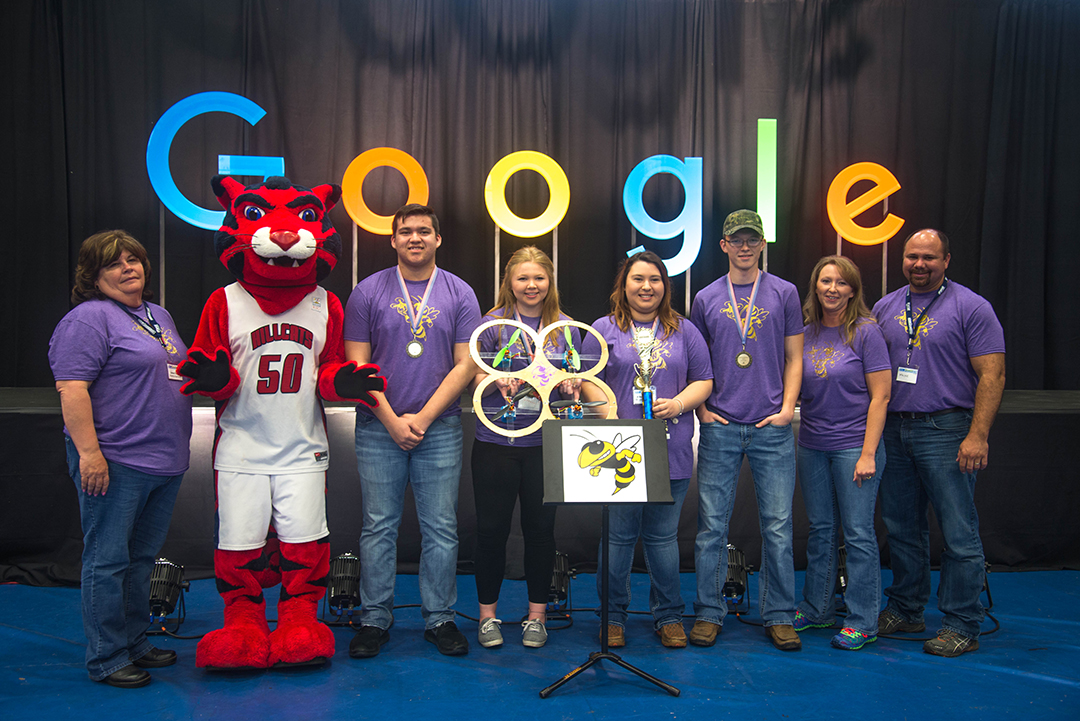 students pose with Hunter the Hillcat at aerogames competition