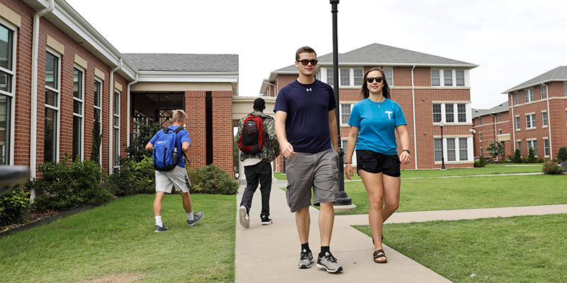 students walking by dorms