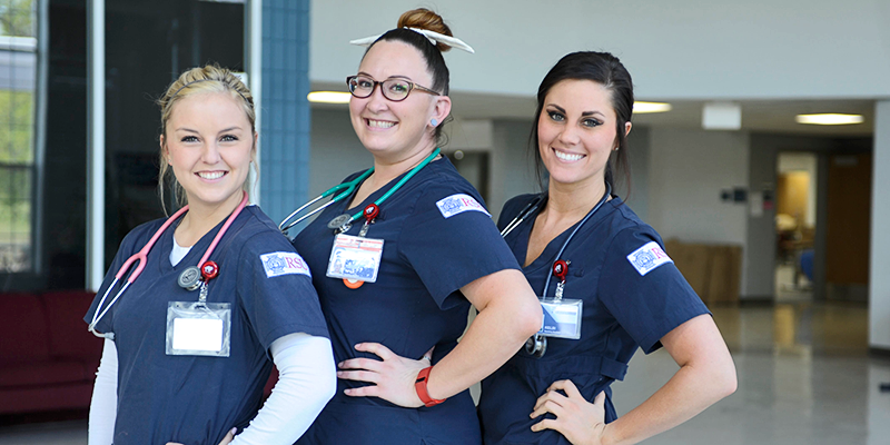 3 girls in scrubs posing for picture