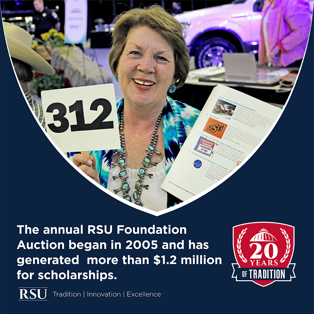 woman holding up bidding number