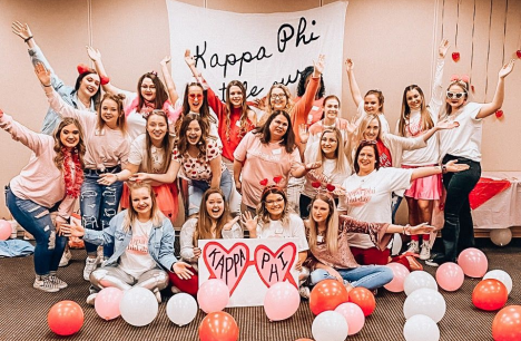 large group of girls posing with balloons