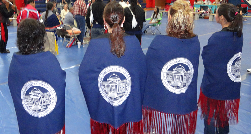 four girls showing rsu logo on back of shaws