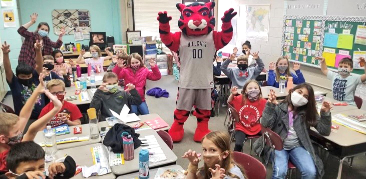 hillcat mascot in classroom with children wearing mask