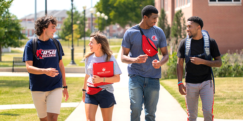 Students walking and talking on campus.