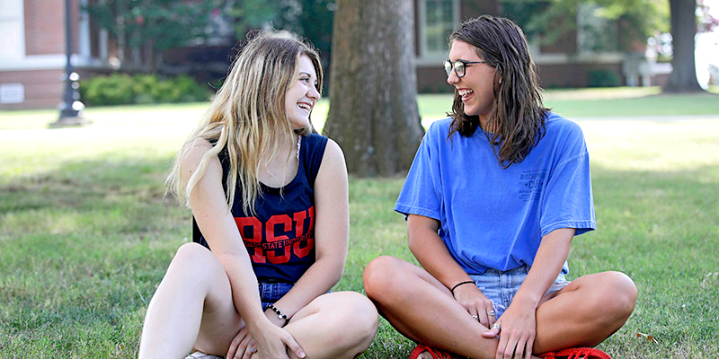 girls sitting on the lawn