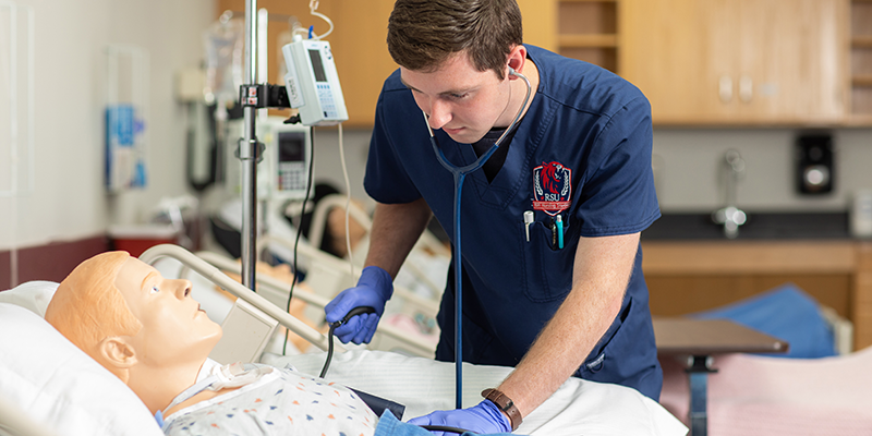 male student nurse check blood pressure