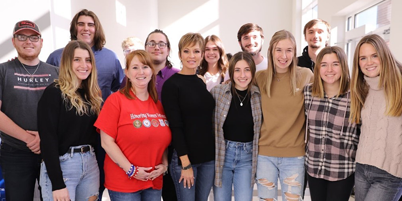 Group of people posing in line for pic