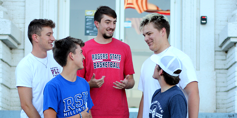 students talking on steps of building