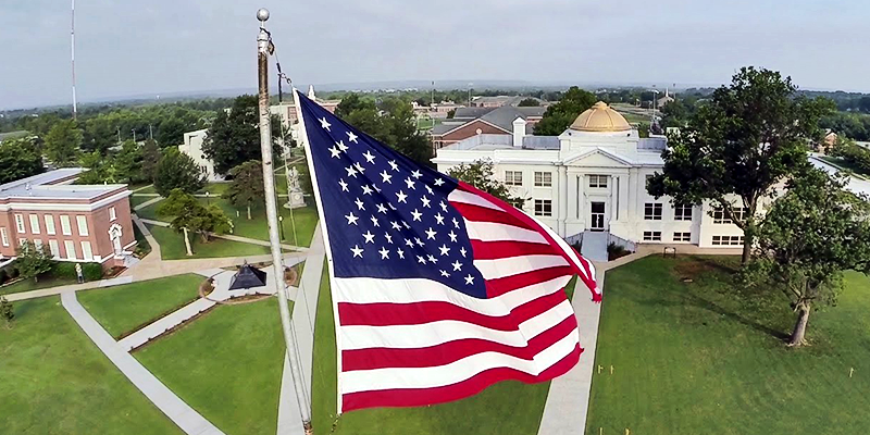 flag flying above white building with gold dome