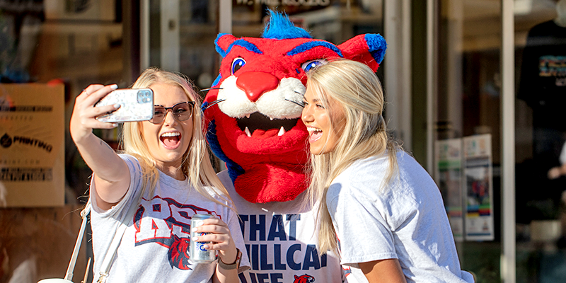 girls taking pic with hunter hillcat mascot