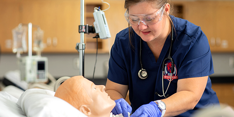 Nursing student practicing a tracheotomy