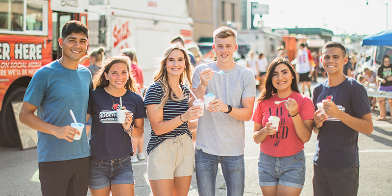 college students outside eating snowcones