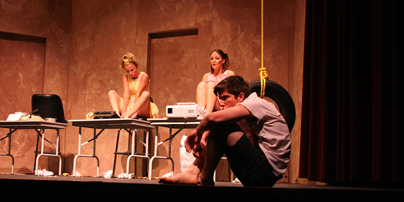 boy and two girls on stage for theatrical performance