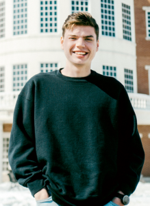 boy smiling with hands in pockets