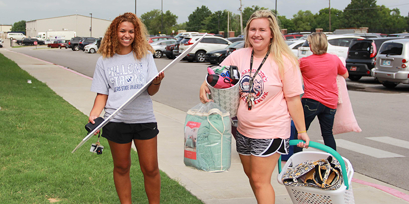 girls carrying mirror and clothing