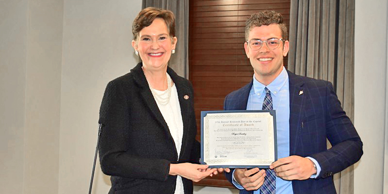 woman handing certificate to man