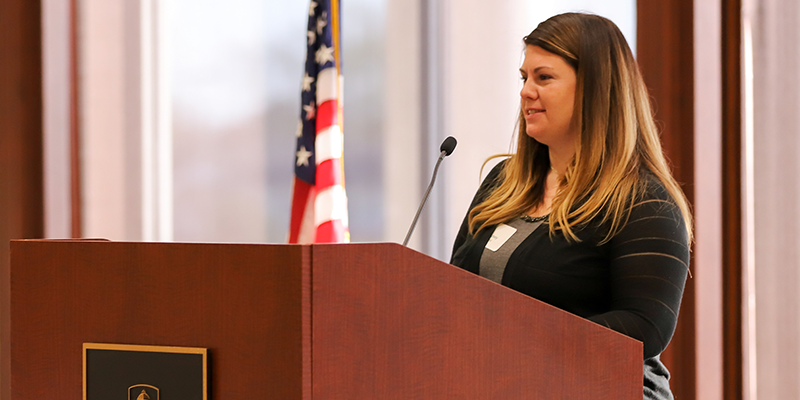 woman speaking behind podium